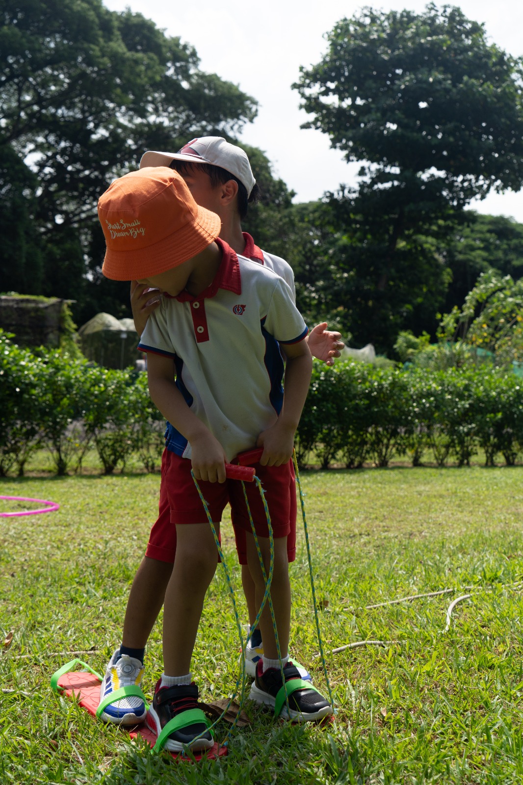 Child in an orange hat exploring outdoors at holiday camp