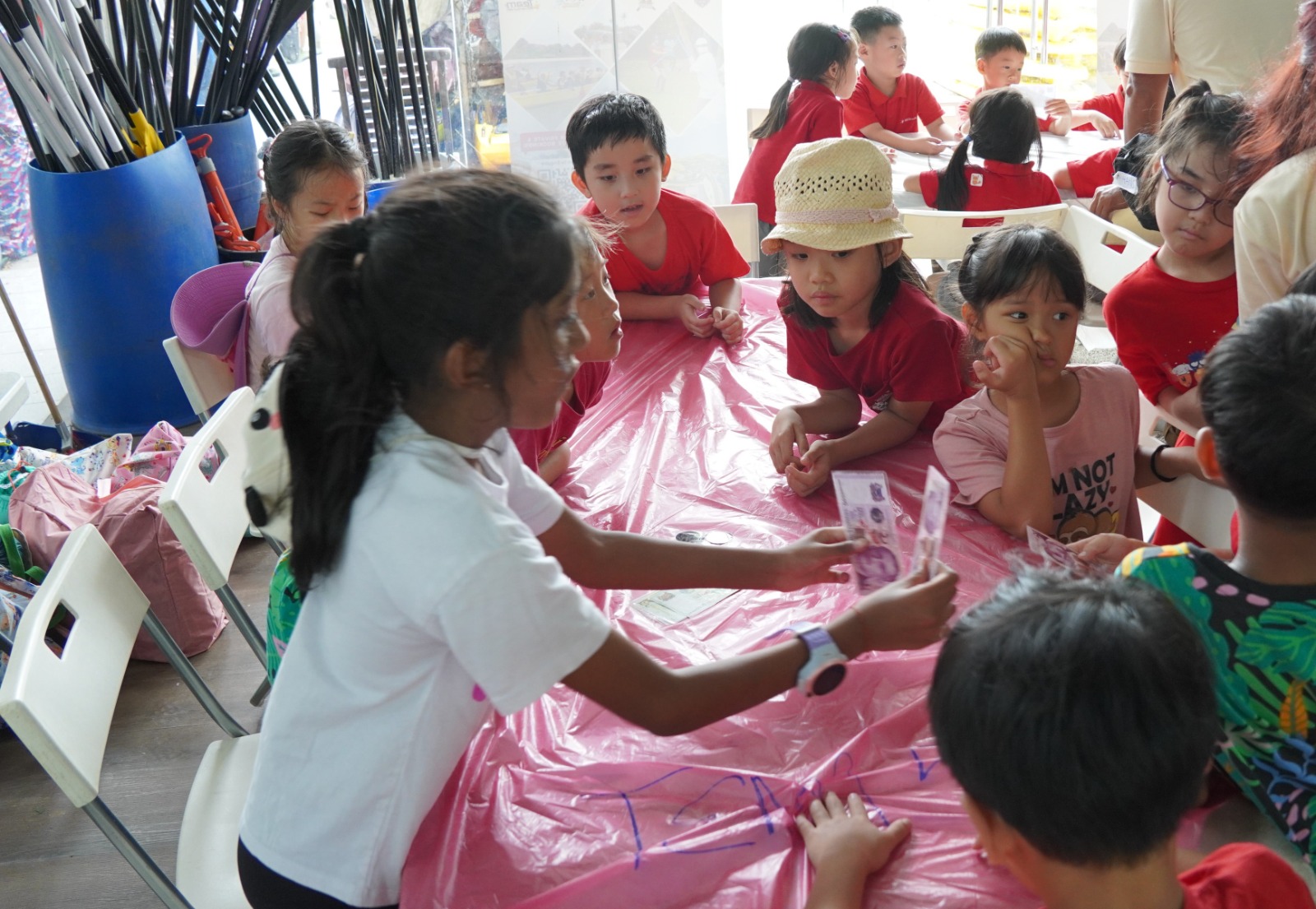 Children working together on a craft activity at holiday camp