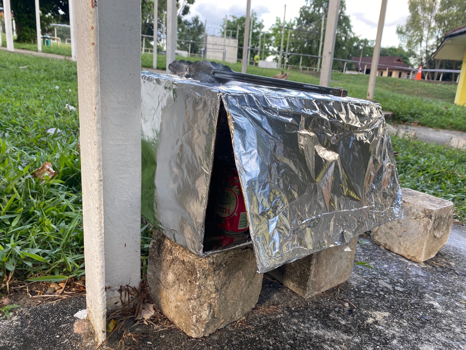 DIY foil solar oven made by kids, set up outdoors